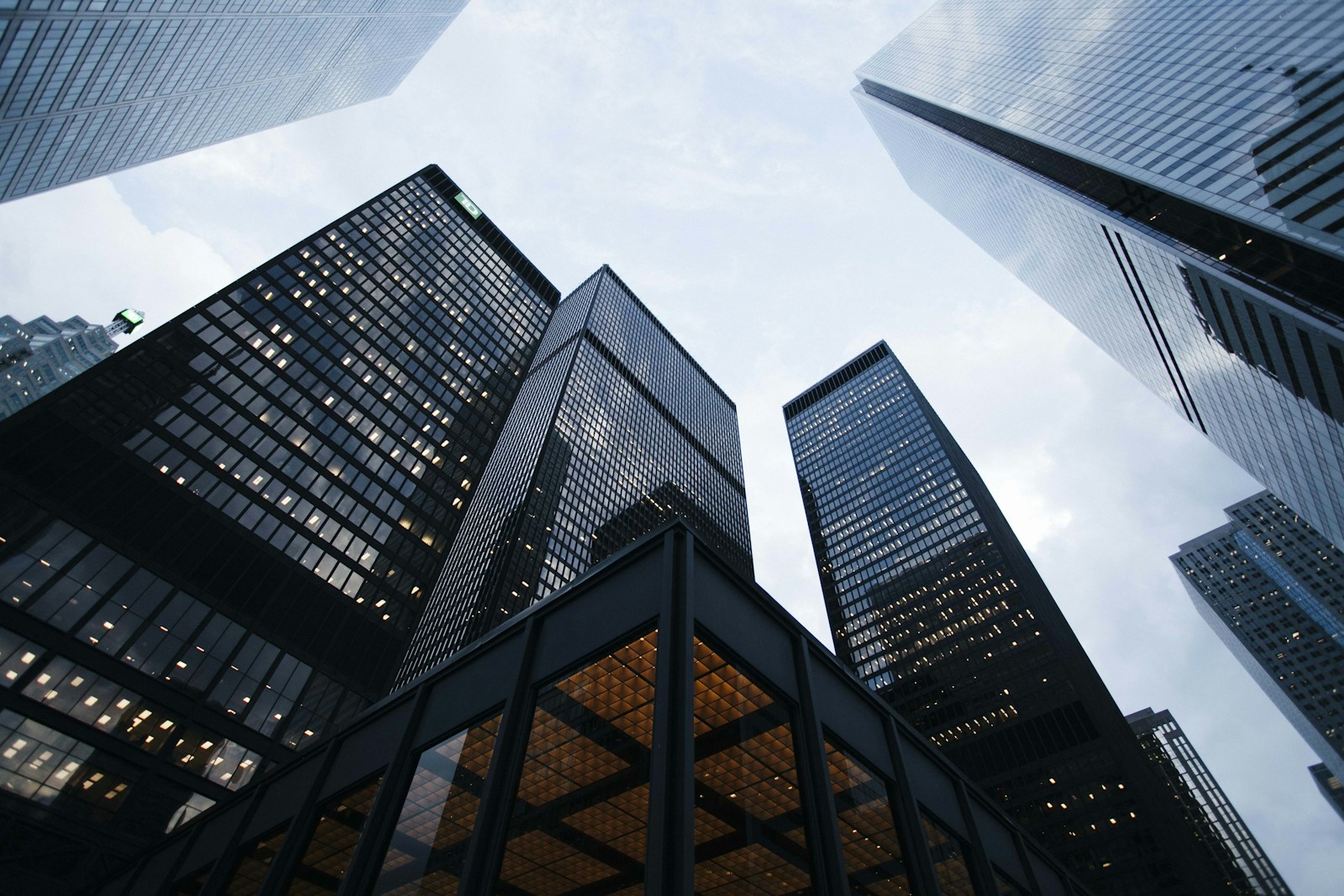 Looking up between the glass towers of a financial district
